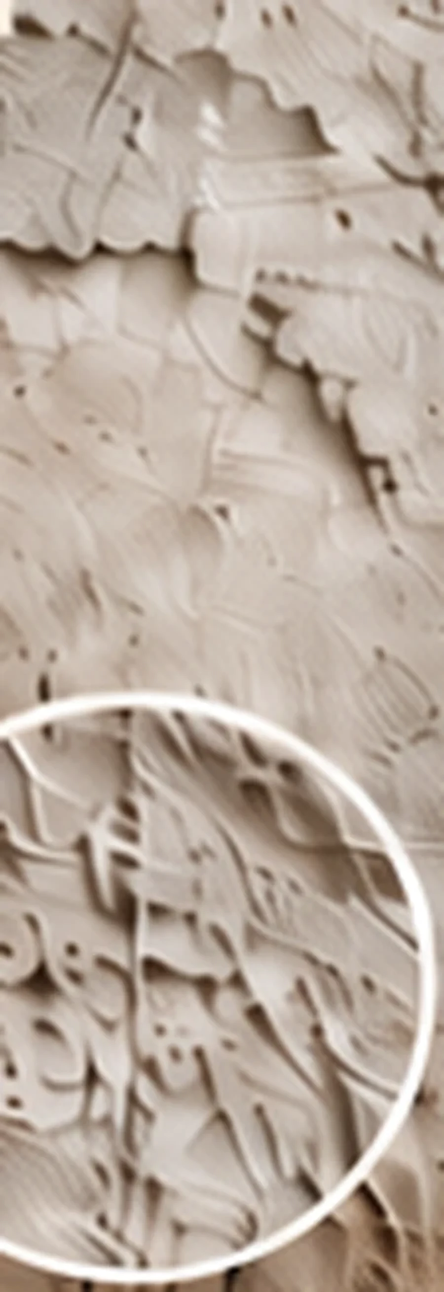 Close view of artwork printed onto rough plaster without concealing its relief